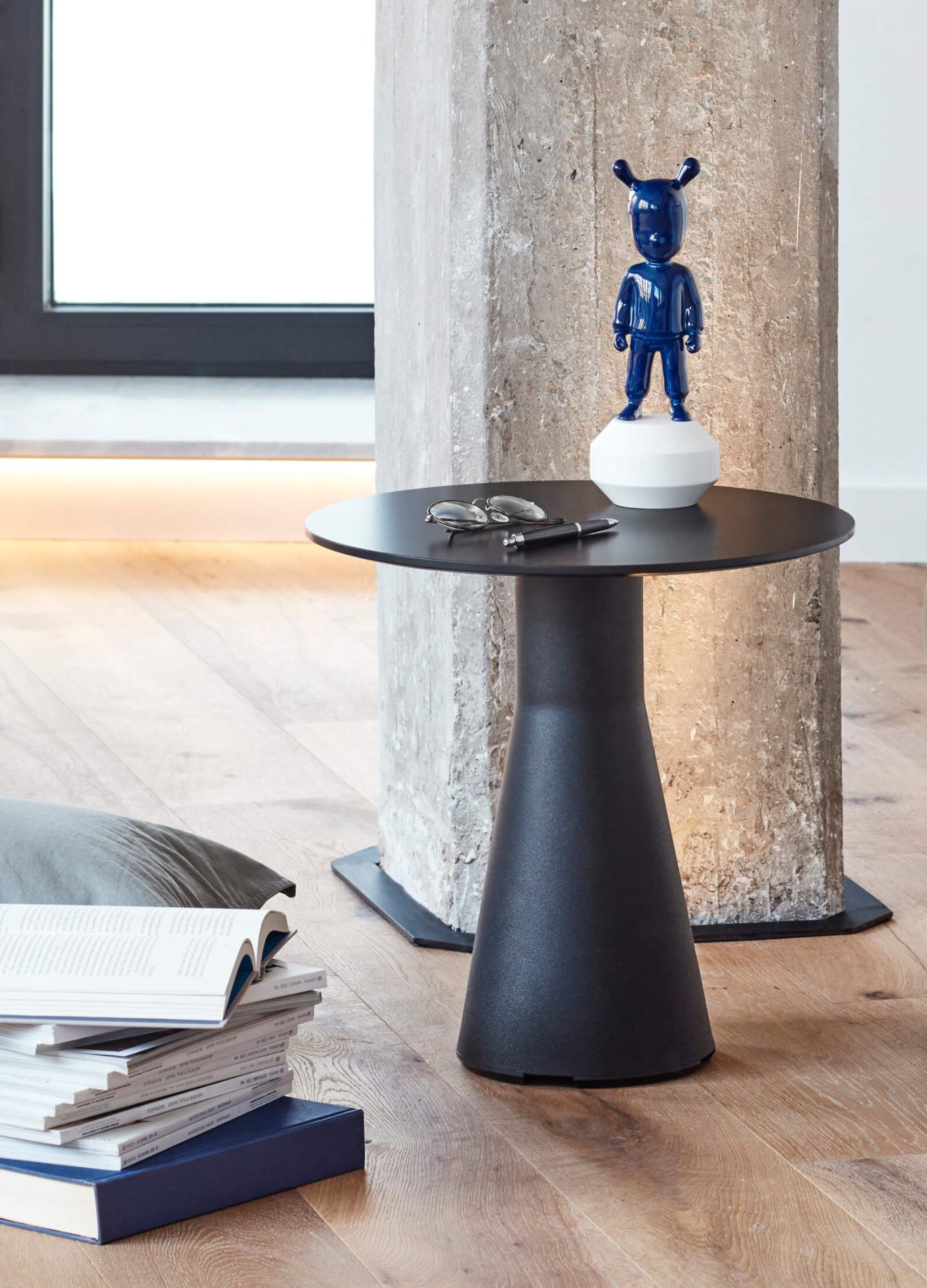 The Indigo Blue Guest Sculpture by Lladró displayed on a black side table